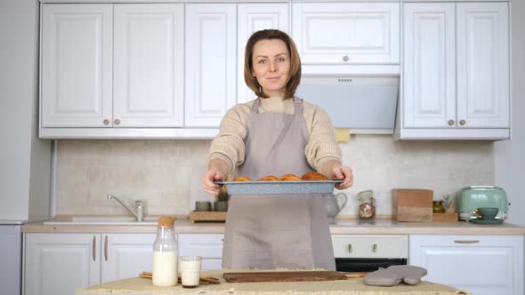 Young Woman Cooking Food On Kitchen At Home. Baking Fresh Croissants. alt