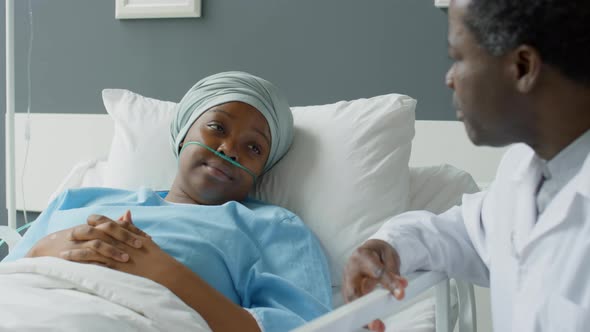 Young Female Patient Talking with Doctor in Hospital Ward alt