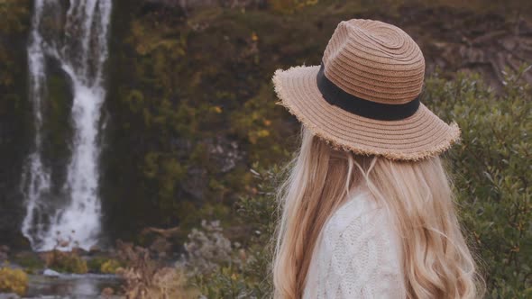 Woman Looking At Waterfall In Iceland alt
