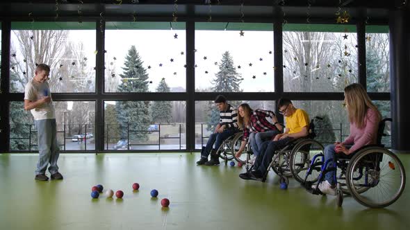 Two Teams of Disabled People Playing Boccia Indoor alt
