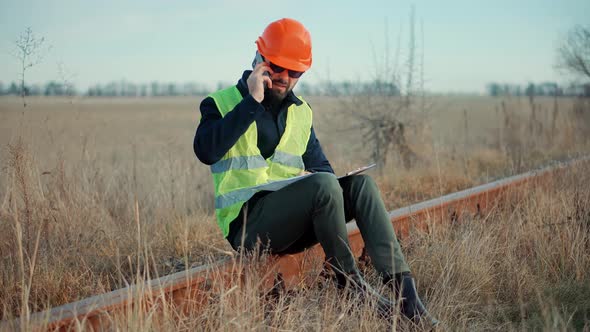 Foreman Designer On Train Station. Civil Engineer Developer With Helmet.Builder Constructor Foreman. alt