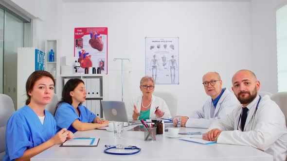 Group of Specialist Doctors Having Video Meeting alt