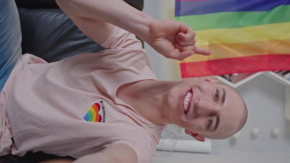 European Gay Activist Doing Live and Talking About LGBTQAI Rights with Rainbow Pride Flag Behind His alt