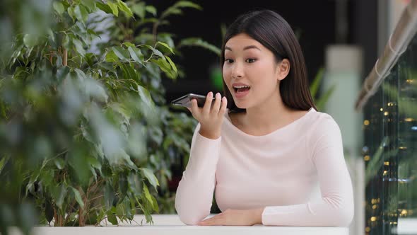 Asian Korean Business Woman Girl Recording Voice Recognition Message on Speakerphone Lady Female at alt