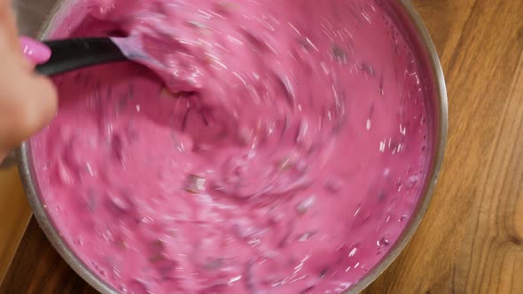 Mixing freshly made beetroot soup in stainless steel bowl alt