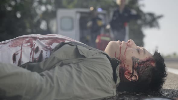 Asian Wounded Man Getting Medical Supports From Paramedics alt