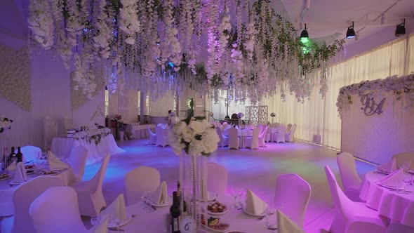 Festive Table with Food and White Bouquet in Interior of Wedding Hall.