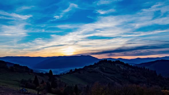 Bright Sun Rises From Behind Distant Mountains in Highland