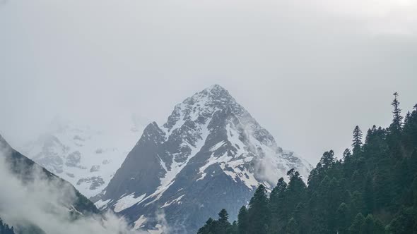 Caucasian Mountain Peak Covered with Snow on Cloudy Day