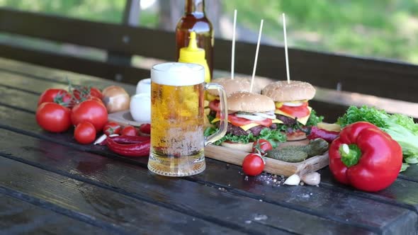 Cheeseburgers Served with French Fries on a Board Outdoors alt