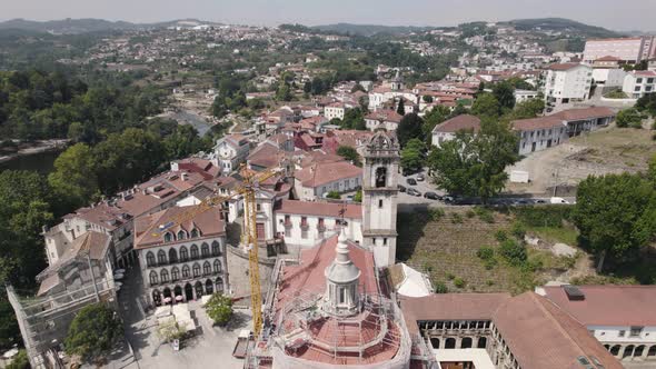 Aerial orbiting over Amarante historic town with São Gonçalo church and Tamega River alt
