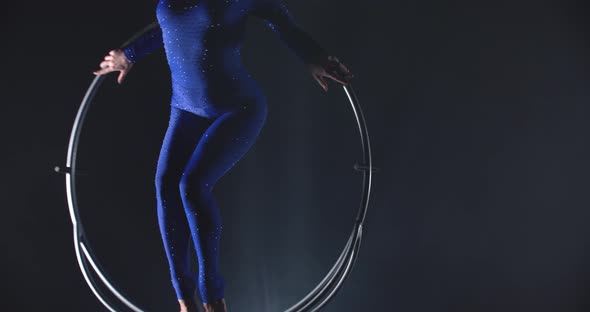 Professional Gymnast is Performing in the Studio in Low Lighting Spinning Hoop alt