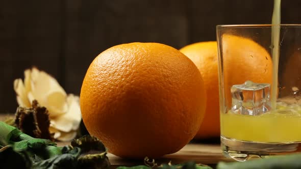 In A Glass With Ice Cubes, Pour Orange Juice And Orange Close