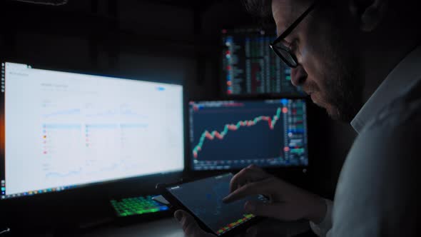 Trader Holds Tablet Analyzes the Stock Market alt