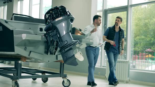Two Men Are Discussing Purchase of a Boat in the Showroom alt