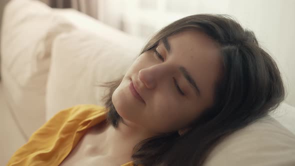 Calm and Relaxed Girl with a Smile Sits on the Couch Comfort Zone Close Up alt