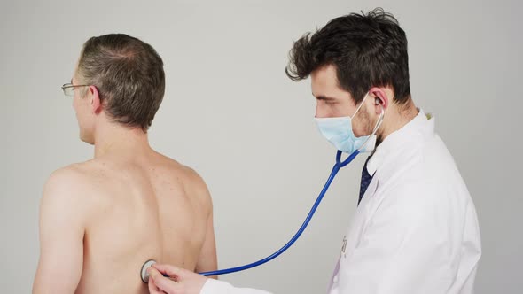 Listening to patient's breathing with stethoscope alt