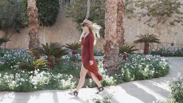 Woman Enjoying Vacation Holidays at Luxurious Hotel Resort Walking to Her Bungalo alt