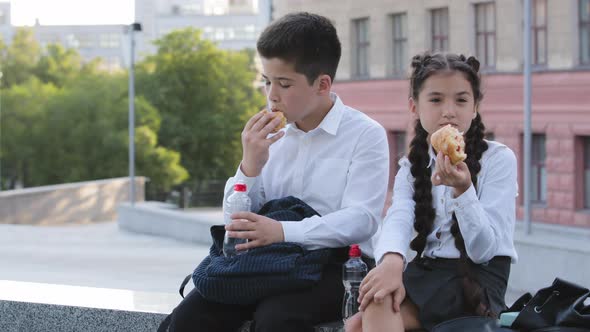 Two Children Eat Buns Outdoors During School Break Hungry Schoolchildren Pupils Students Enjoing alt