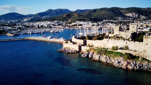 View from drone on full of yachts Bodrum harbour and ancient Kalesi castle in Mugla in Turkey alt