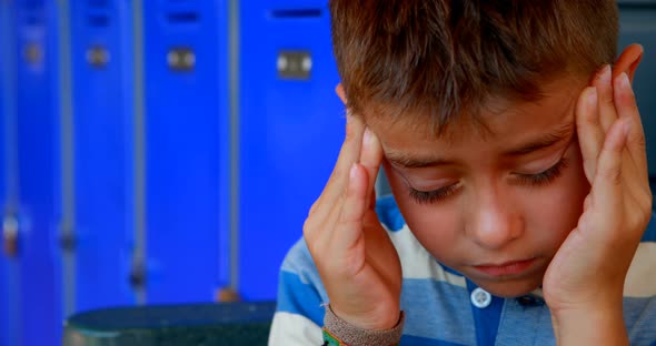 Schoolboy suffering from headache 4k alt