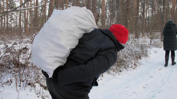 Young Woman and Aged Man with Large White Bag Walk alt