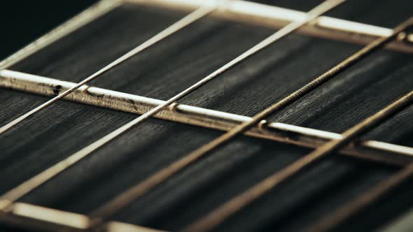Fretboard details of six-string electric guitar. Worn out, rusty strings closeup alt