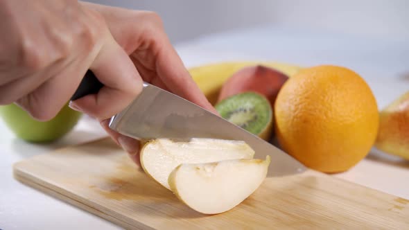 Hands Woman Cuts a Pear on a Wooden Board Vegetarian Ingredient Cook r
