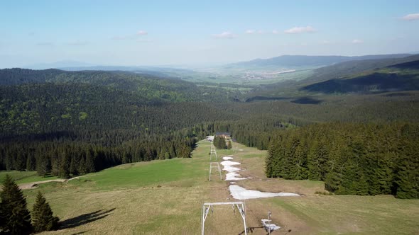 Aerial Shot From a Drone Flying Over the Ski Resort in the Spring Above the Cable Car