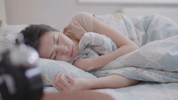 Asian Woman Sleeping in Her Bedroom alt