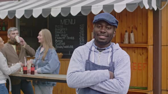 Portrait of owner small business near his food booth