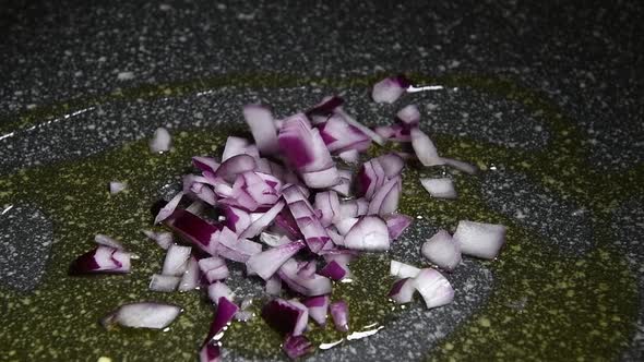 Italian Tropea red onion falls on a frying pan alt
