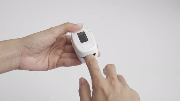 Hand with pulse oximeter or blood oxygen level measure monitor device with display alt