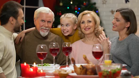 Family Hugging and Looking at Camera alt