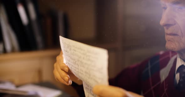 Senior Professional Analyzing Documents at Office alt