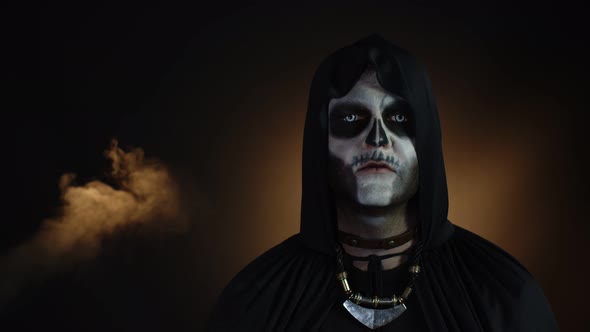 Sinister Man with Halloween Skeleton Makeup Making Faces, Looking at Camera, Trying To Scare alt