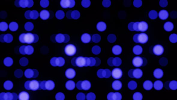 Horizontal blurred bokeh circles. Motion animation of blurred circles in blue on black background.
