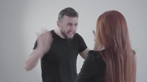 Portrait of Irritated Young Caucasian Man Yelling at Unrecognizable Girlfriend or Wife alt