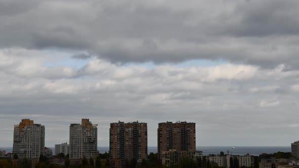 Cloudscape time lapse over urban skyline near waterfront