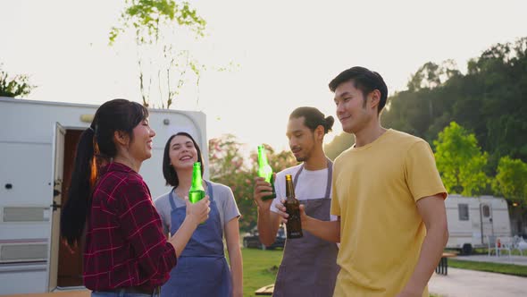 Group of Asian man and woman friends are having holiday trip party outdoor in the evening together. alt