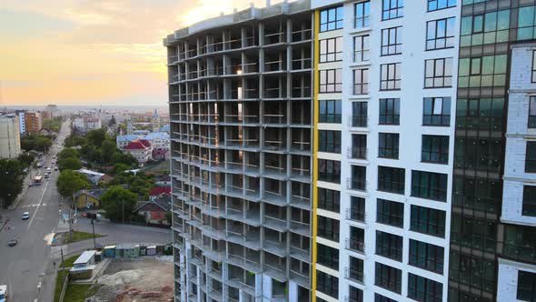 High Residential Apartment Building with Monolithic Frame Under Construction at Sunset alt