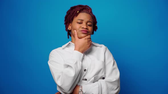 Pensive Young Afro Woman Thinking About Something Against Blue Background