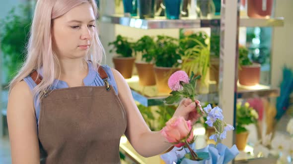 Calm Woman with Loose Hair Enjoys Making Decorative Bouquet alt