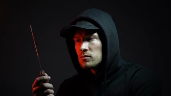 Pensive Man in Hoodie Holding Knife, Thinking About Doing Crime, Melee Weapon alt