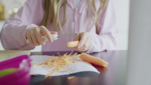 Girl peeling carrot