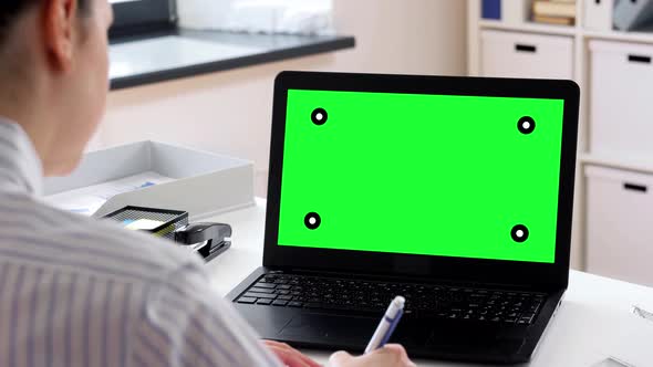 Woman with Laptop and Charts Working at Home alt