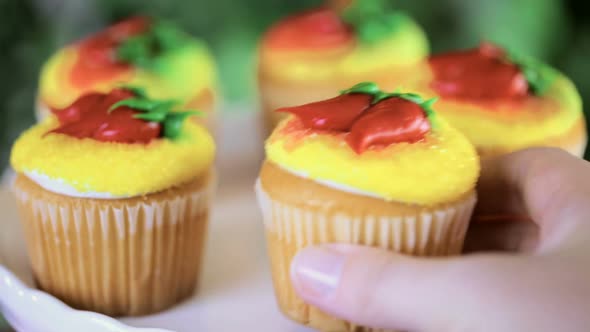Cupcakes decorated with red chili peppers for Cinco de Mayo. alt