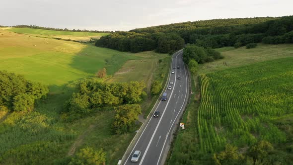 Aerial Landscape of Green Meadows and Highway on Summer Sunny Day