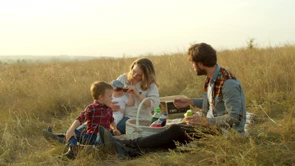 Happy Boy Playing with Parents During Picnic