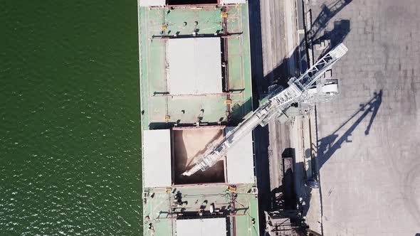 Loading Grain Onto a Cargo Ship for Transportation By Sea By a Conveyor Belt Machine